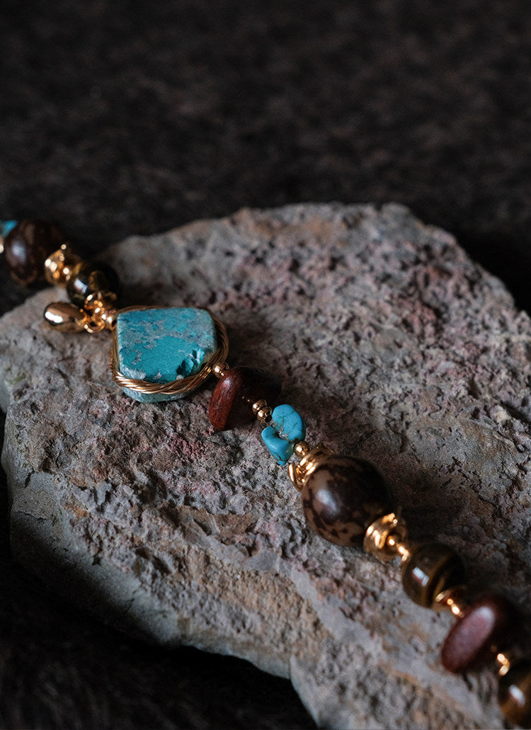 Moon Between Pines turquoise bracelet on raw stone, showing full bead arrangement